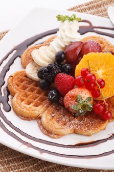 waffle with fresh fruit topping with maple syrup