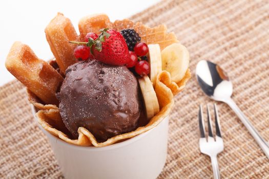 vaniila waffle with chocolate ice cream decorate with mix berry and banan