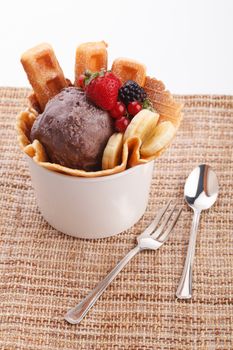 vaniila waffle with chocolate ice cream decorate with mix berry and banan