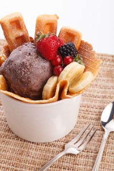 vaniila waffle with chocolate ice cream decorate with mix berry and banan