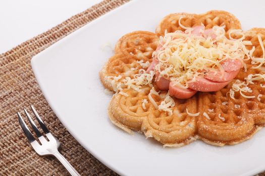 waffle with sausace topping with shred cheese