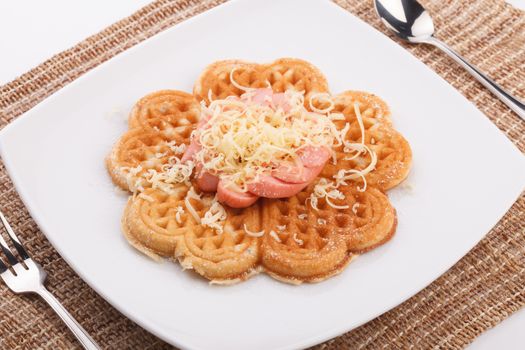 waffle with sausace topping with shred cheese
