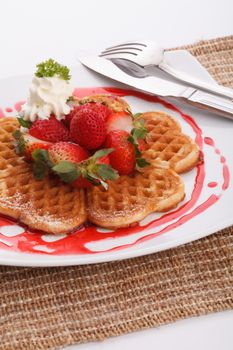 waffle topping with strawberry and decoration with strawberry sauce