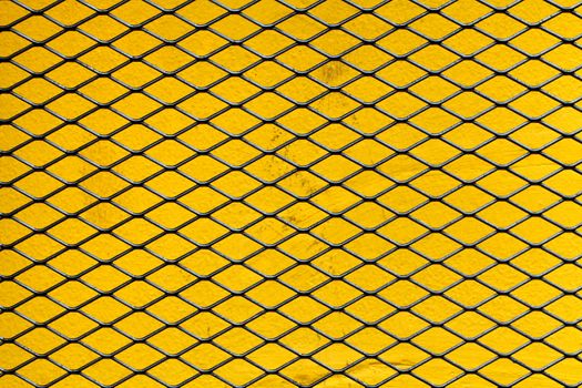 a iron net on a yellow wall