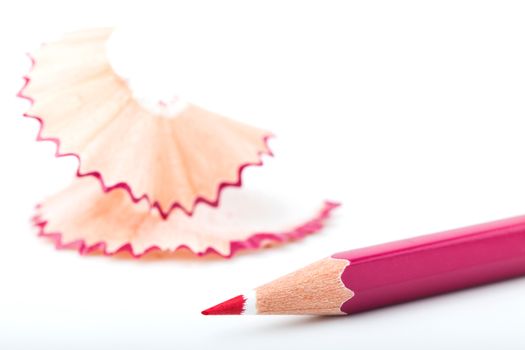 tip point of pink pencils and shavings from sharpening on white background