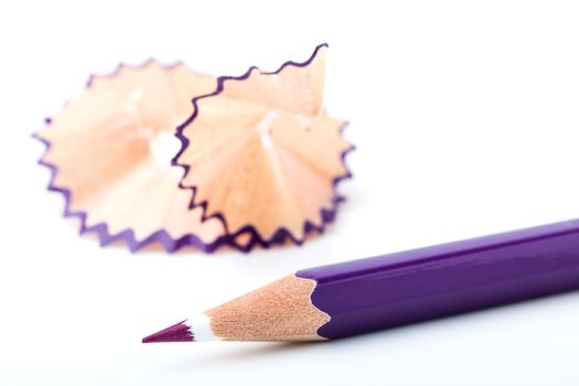 tip point of violet pencils and shavings from sharpening on white background
