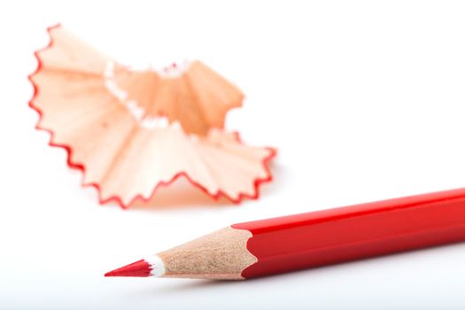 tip point of red pencils and shavings from sharpening on white background