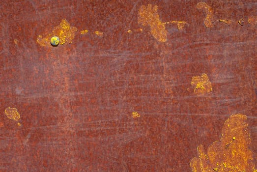 rusty iron surface covered with old chipped yellow color paint, which has long been influenced by different climatic conditions