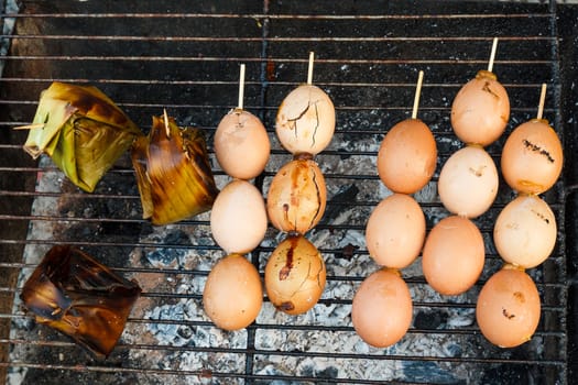 Grilled eggs in stick.With grilled pork in pandan.