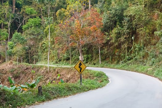 Empty curved road on hill.