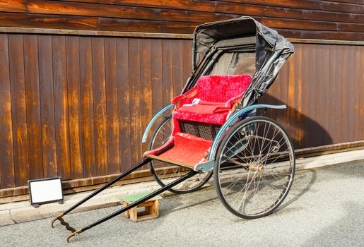 Japanese rickshaw parked beside wooden wall in Takayama,Japan.