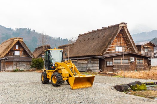 Bulldozer beside house at Shirakawago,Japan.