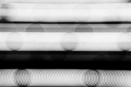 Row of white bokeh in the dark.