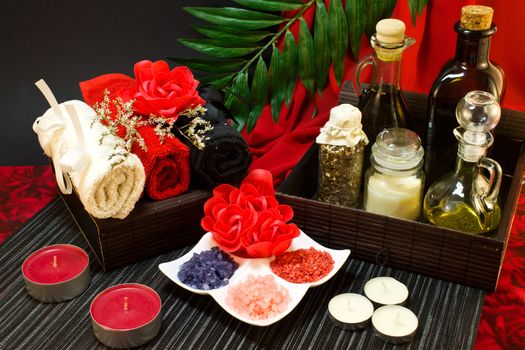 Still life of candle, tools for massage creams for skin care and bath salt.