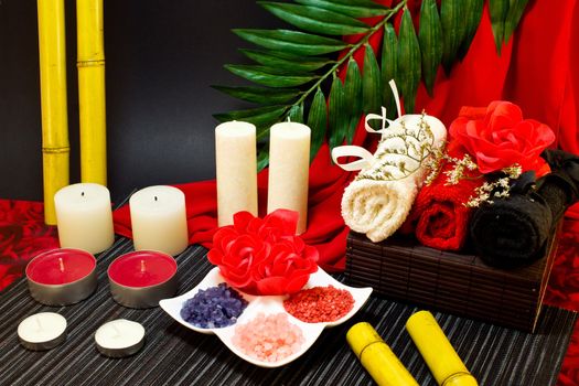 Still-life of the towels and bath salt decorated with roses and bamboo