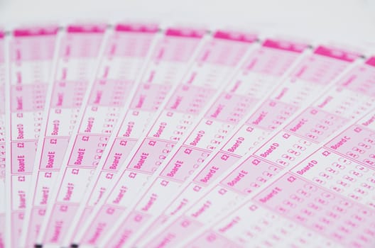 Blank lotto tickets scattered on white
 background
