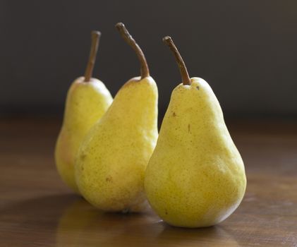 Fresh pears on wooden table, shallow depth of field