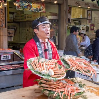 Tokyo, Japan - November 13, 2015: Tsukiji fish market. Tsukiji is the biggest freshest fish market in the world. Shop around Tsukiji peddling their giant crabs.