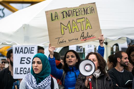 SPAIN, Madrid: A protester holds a sign which reads La indiferencia mata during a rally at Sol Square in Madrid, Spain on April 22, 2015 to protest against EU-Turkey agreement and to show support to refugees for a 24 hours vigil.