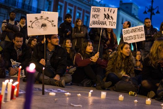 SPAIN, Madrid: Protesters gather with candlelights during a rally at Sol Square in Madrid, Spain on April 22, 2015 to protest against EU-Turkey agreement and to show support to refugees for a 24 hours vigil.
