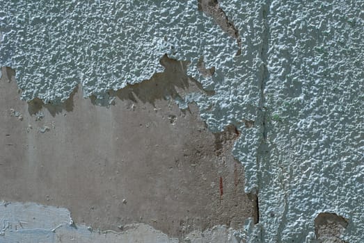 fragment of a concrete wall, which has undergone deformation due to prolonged exposure to various climatic conditions