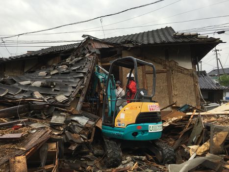 JAPAN, Mashiki: A man with a digger clears out the rubble of a collapsed house following an earthquake, on April 23, 2016 in Mashiki near Kumamoto, Japan. As of April 20, 48 people were confirmed dead after strong earthquakes rocked Kyushu Island of Japan. Nearly 11,000 people are reportedly evacuated after the tremors Thursday night at magnitude 6.5 and early Saturday morning at 7.3.
