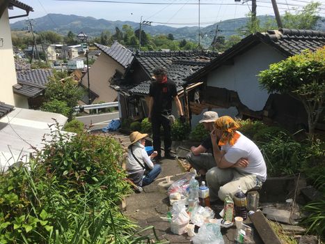 JAPAN, Mashiki: People have lunch in the rubble of collapsed neighborhood following an earthquake, on April 20, 2016 in Mashiki near Kumamoto, Japan. As of April 20, 48 people were confirmed dead after strong earthquakes rocked Kyushu Island of Japan. Nearly 11,000 people are reportedly evacuated after the tremors Thursday night at magnitude 6.5 and early Saturday morning at 7.3.
