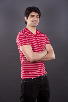 handsome east indian man wearing red shirt on light grey background