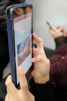 Close up image of  people using digital tablet  in subway train,social media life