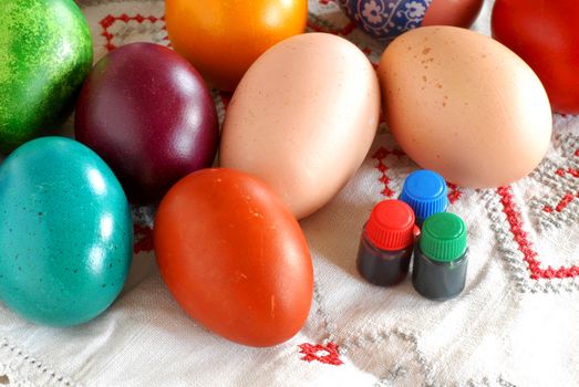 many various colorful easter eggs with liquid paint bottles