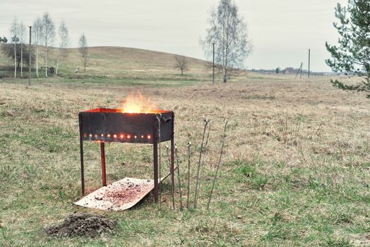 brazier with burning woods, charcoal preparation to bake shashlik