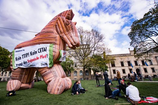 GERMANY, Hanover: A Trojan horse stands on field as thousands attend a rally in Hanover, Germany against the Trans-Atlantic Trade and Investment Partnership (TTIP) on April 23, 2016. US President Barack Obama and German Chancellor Angela Merkel are set to open the world's largest industrial trade fair in Hanover on April 24, and leaders will reportedly congregate in New York City the following day to continue talks on TTIP.