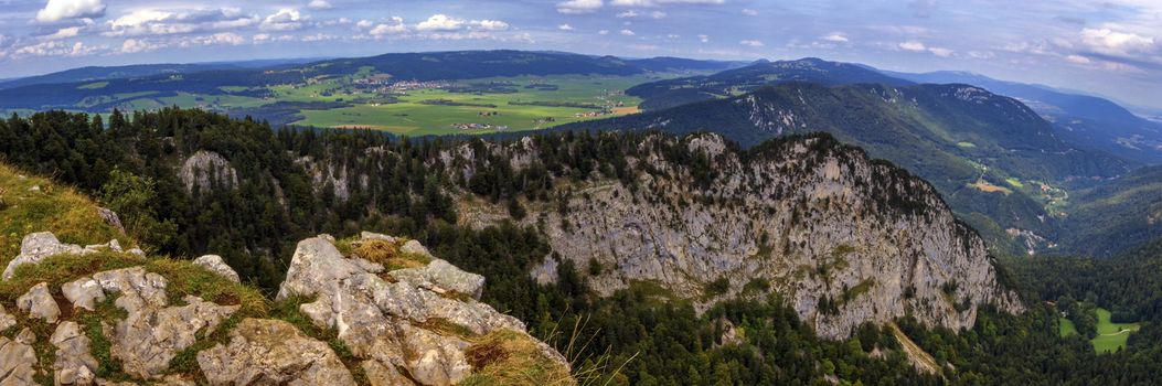 Panoramic view from the Creux-du-Van or Creux du Van rocky cirque at sunrise, Neuchatel canton, Switzerland