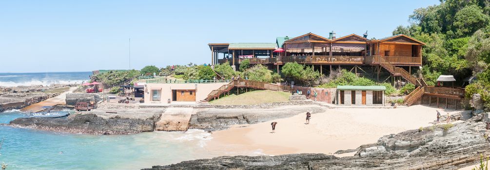 STORMS RIVER MOUTH, SOUTH AFRICA - FEBRUARY 29, 2016:  Unidentified tourists at the restaurant, a beach and a small harbor at Storms River Mouth