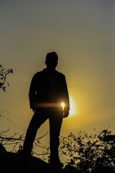 Man standing looking evening sun