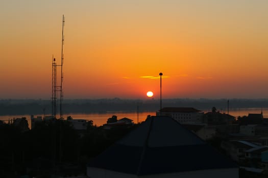Sunrise over Mekong River in a Mukdahan city skyline