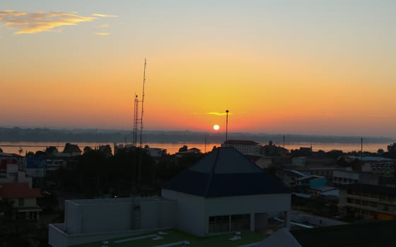 Sunrise over Mekong River in a Mukdahan city skyline