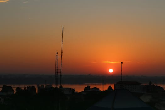 Sunrise over Mekong River in a Mukdahan city skyline