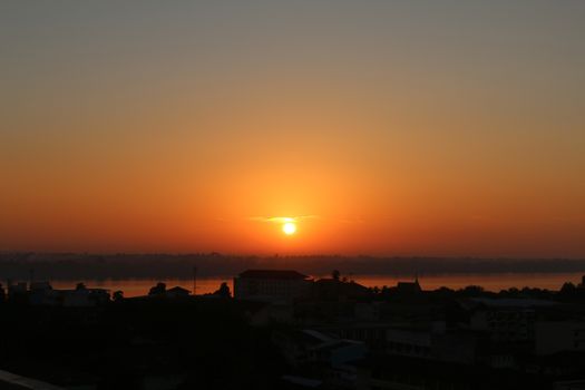 Sunrise over Mekong River in a Mukdahan city skyline