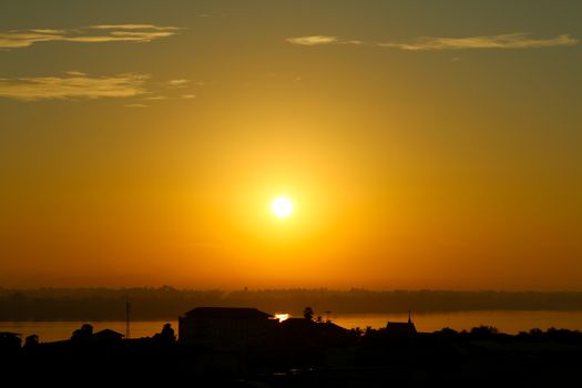 Sunrise over Mekong River in a Mukdahan city skyline