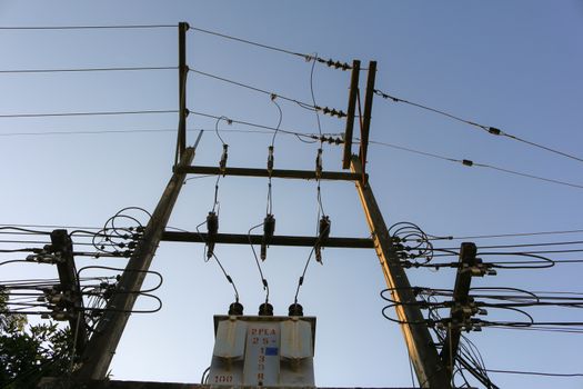 Transformer and power lines on electric pole.