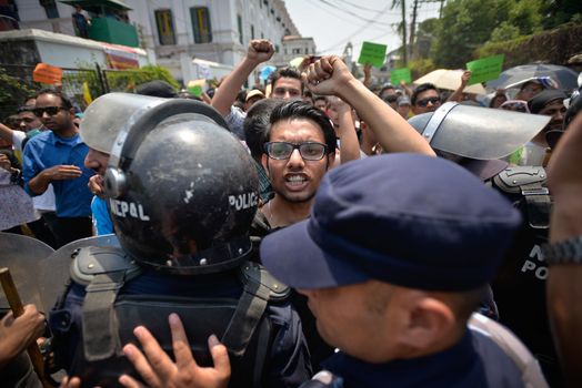 NEPAL, Kathmandu: Nepalese police push back demonstrators protesting against delayed government reconstruction efforts in Kathmandu on April 24, 2016, a year after a devastating earthquake. Nepal held memorial services on April 24 for the thousands killed in a massive earthquake one year ago, as victims still living in tents accused the government of failing them.