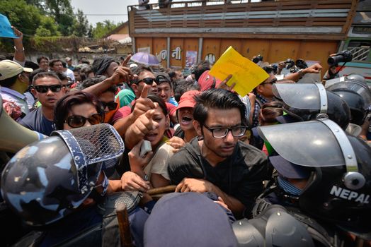 NEPAL, Kathmandu: Nepalese police push back demonstrators protesting against delayed government reconstruction efforts in Kathmandu on April 24, 2016, a year after a devastating earthquake. Nepal held memorial services on April 24 for the thousands killed in a massive earthquake one year ago, as victims still living in tents accused the government of failing them.