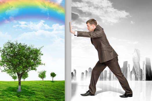 Businessman changing nature landscape with rainbow on grey city