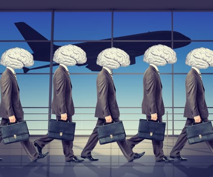 Goup of businessmen with brains instead heads in airport