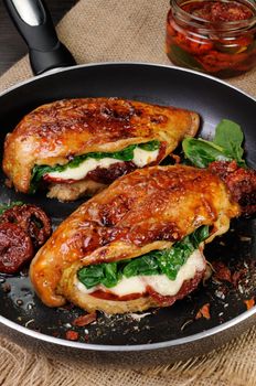 Baked chicken breast stuffed with mozzarella, spinach, sun-dried tomatoes