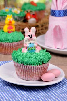 Muffin decorated Easter bunny sitting on the grass