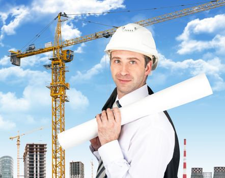 Smiling businessman in helmet holding blueprints on building site