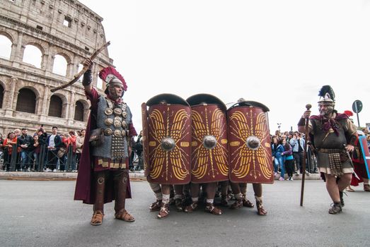 ITALY, Rome: Men dressed as ancient roman centurions parade near the Colosseum to commemorate the legendary foundation of the eternal city in 753 B.C, in Rome on April 24, 2016. 