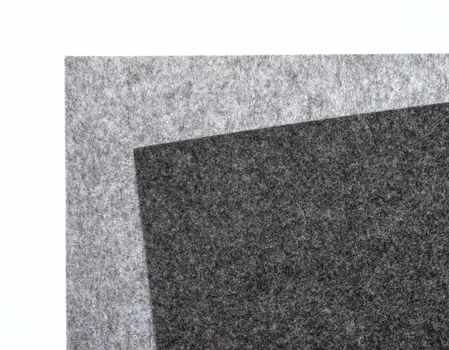 gray felt pieces on a white background
